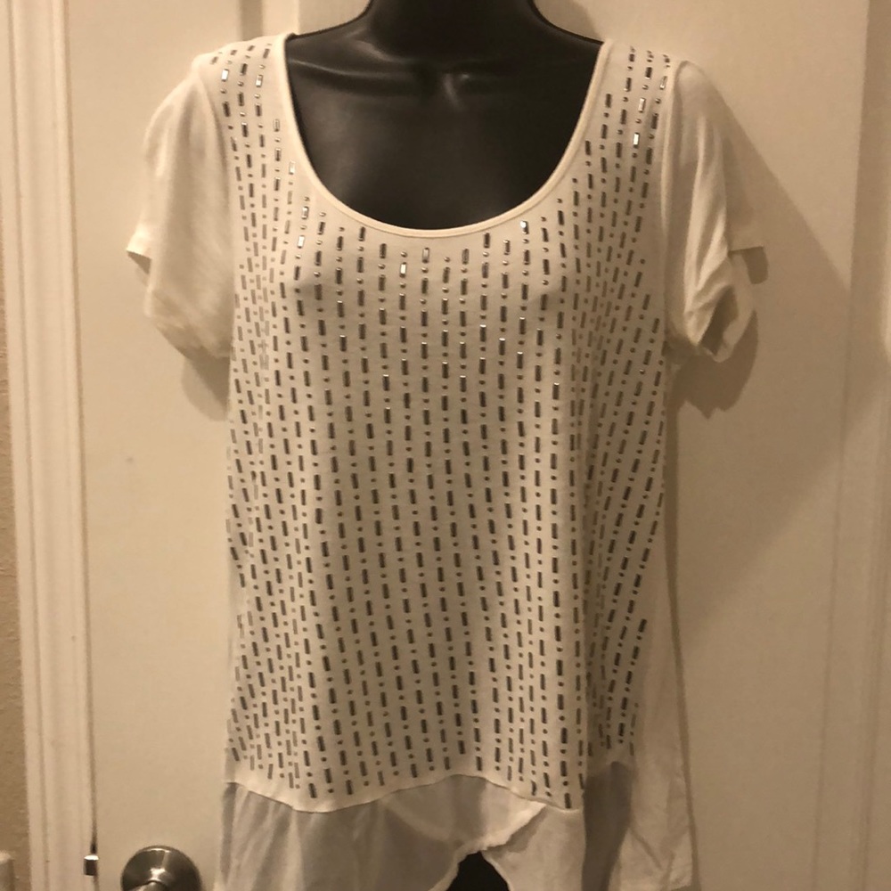 Cream color with silver metallic studs. Short sleeved.